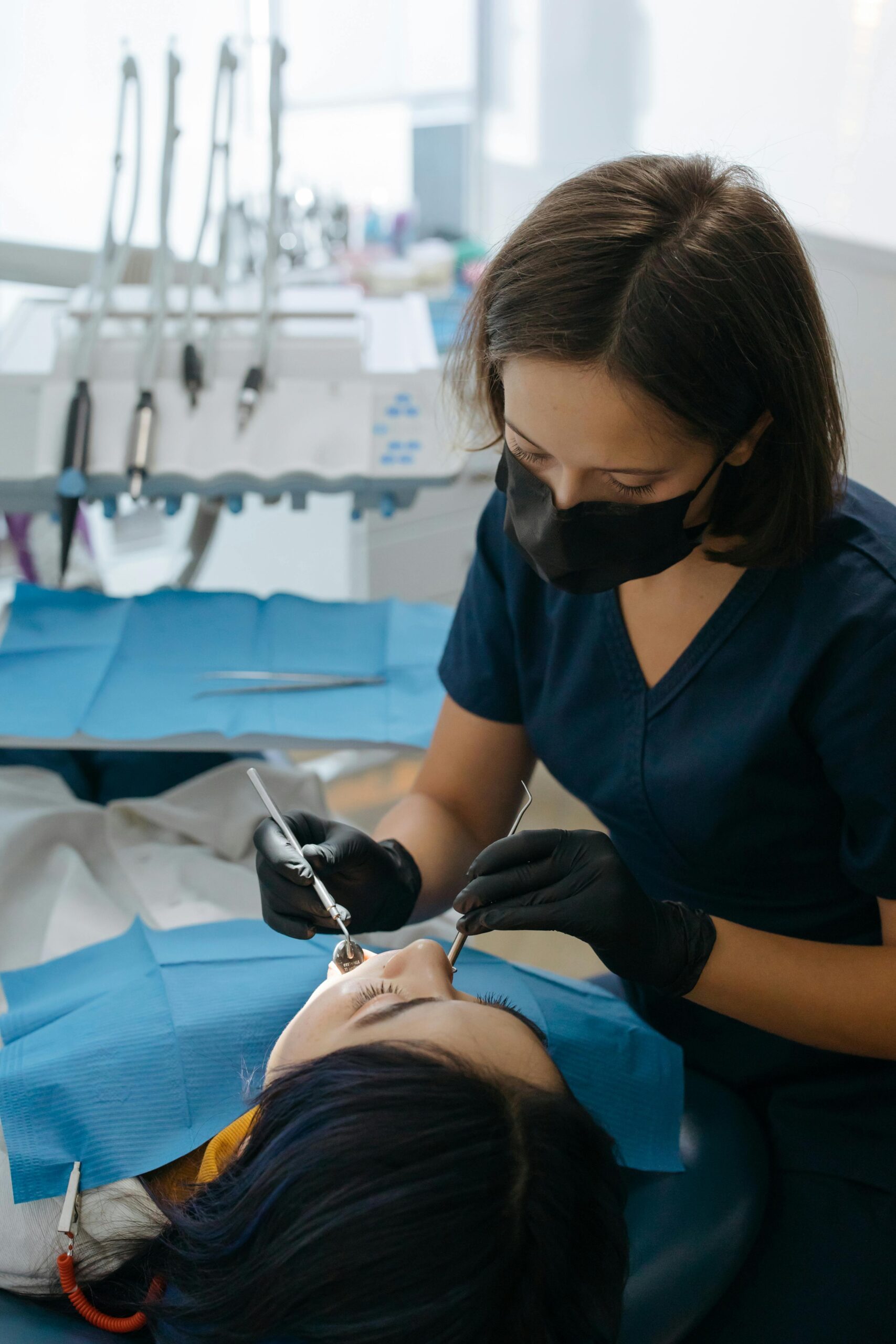 Dentist performing dental care procedure on patient in clinic setting.